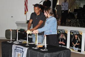 Layla and DeWaylon performing the ceremony to be inducted into the NHS.