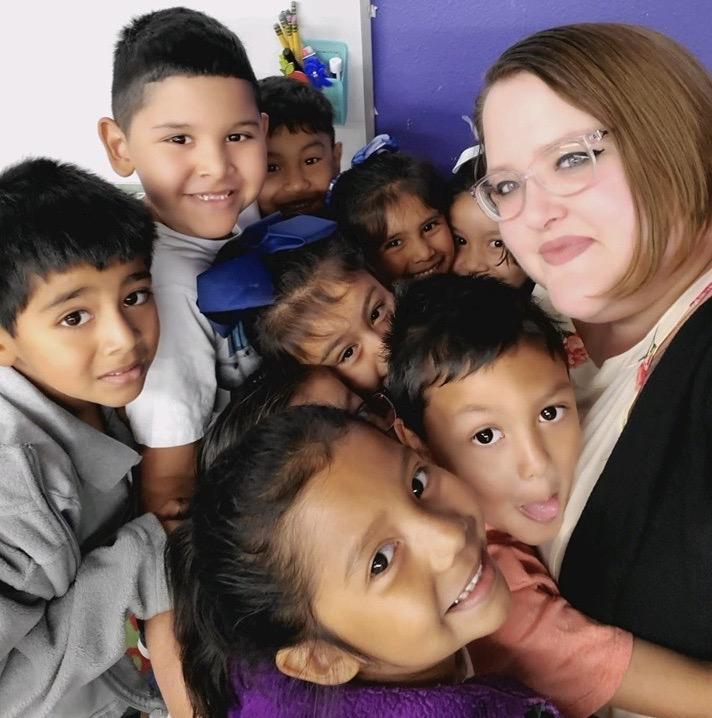 Teacher with kids hugging