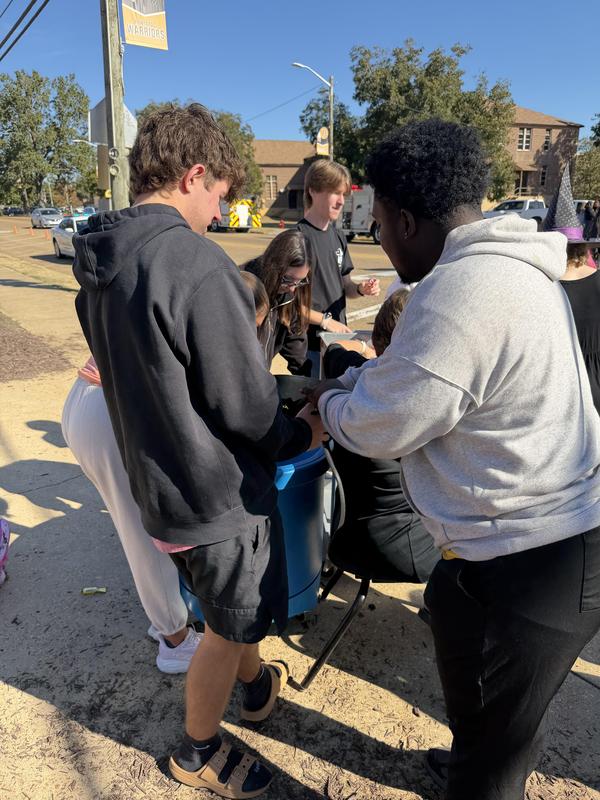 High School students pass out candy