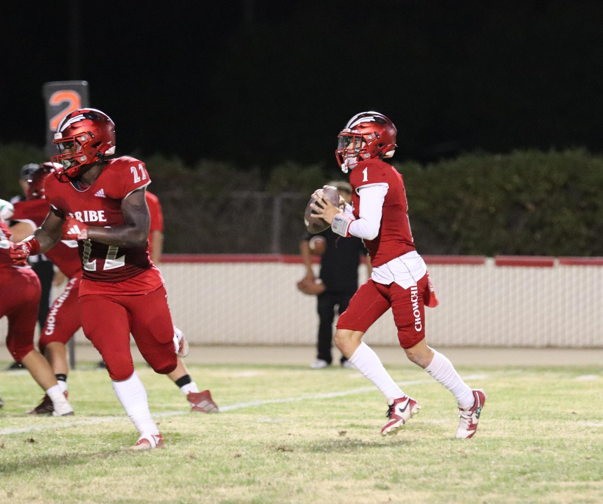 varsity football players in action against Riverdale