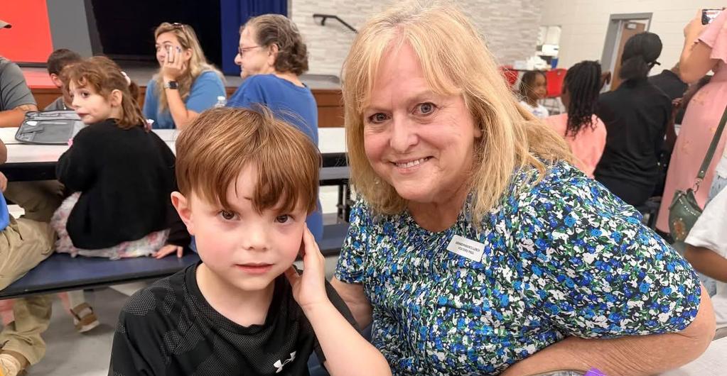 Student eating lunch with grandmother
