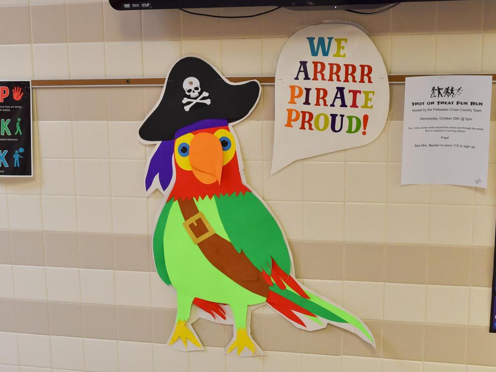 A Pirate Parrot saying, "WE ARRRRRR PIRATE PROUD!" hanging on the hallway wall.