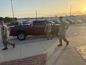 Adopt-A-Unit soldiers open car doors for students