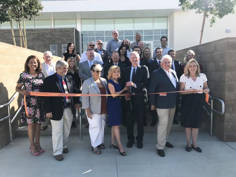 Image of Superintendent Vicki Engbrecht, governing board members, community leaders, district and school administrators taking part in the ribbon-cutting ceremony opening Castaic High School