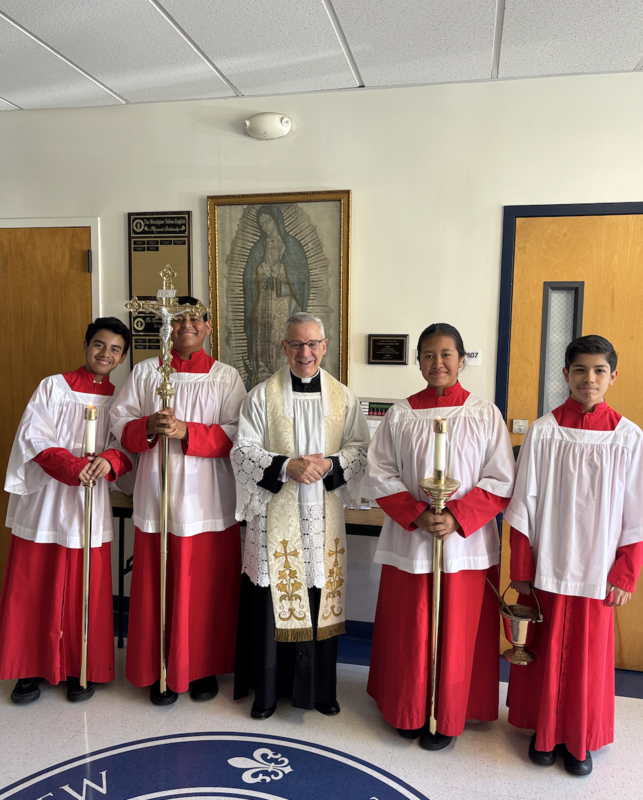 Fr. Gonzalez with student altar servers who helped bless our school
