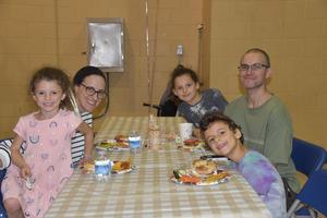 A family eating at the fall festival