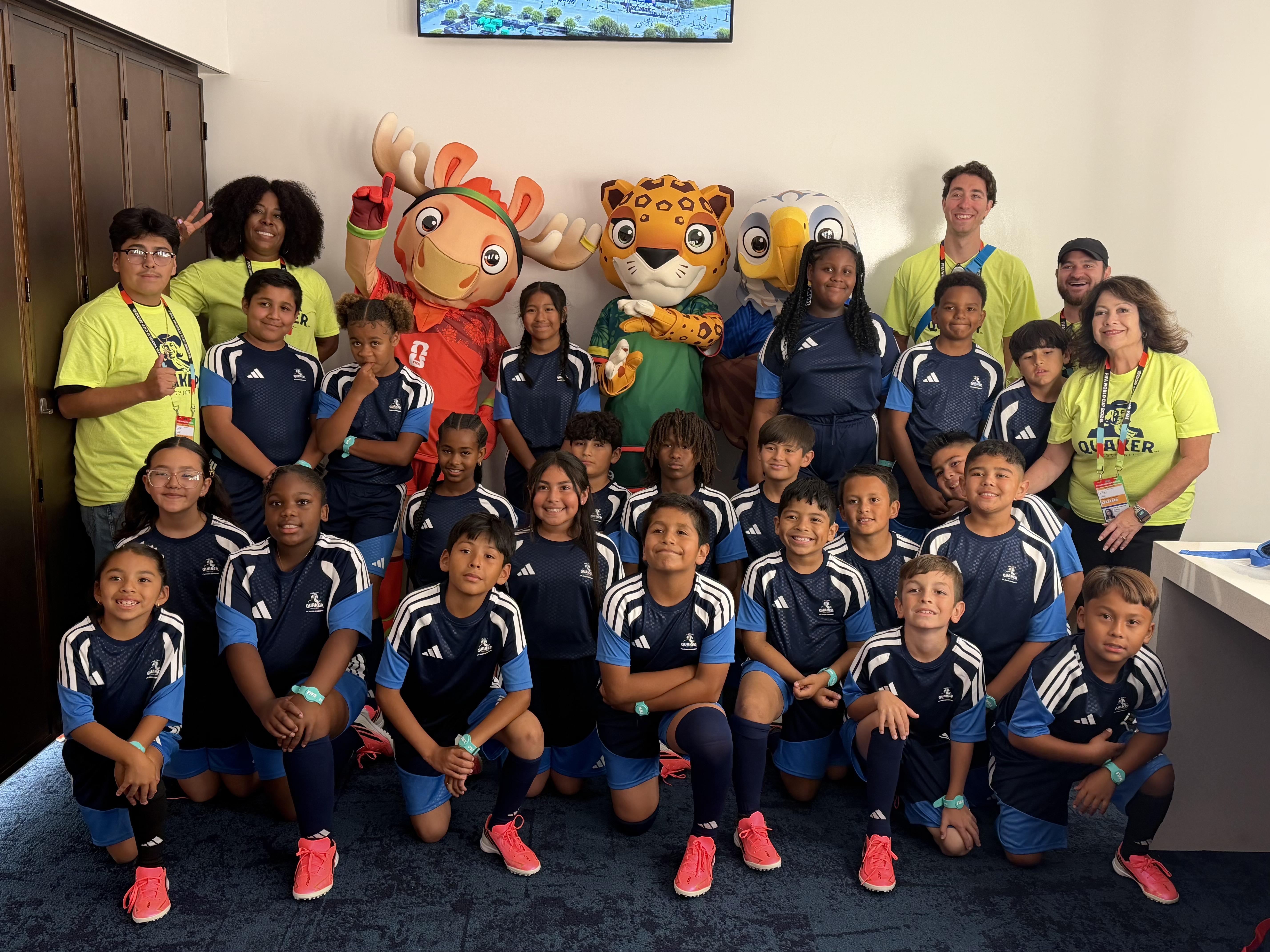 ERUSD students pose with World Cup mascots and staff.