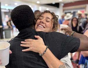Man hugs woman