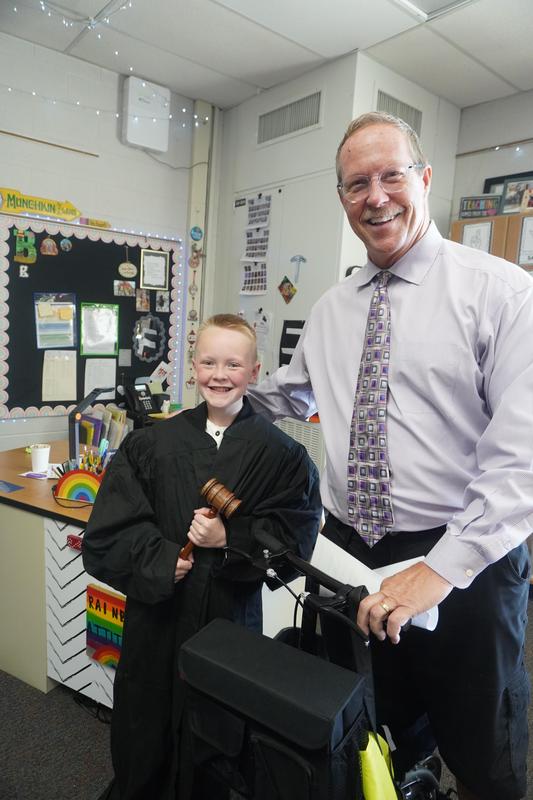 Barry County Judge Michael Schipper lets a Page 5th grader try on a judge's robe and hold the gavel.