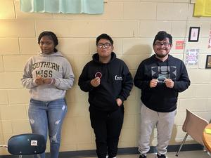 Students showing off their glow in the dark bracelets