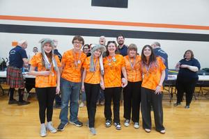 A TK OM team receives their medal at the regional competition.