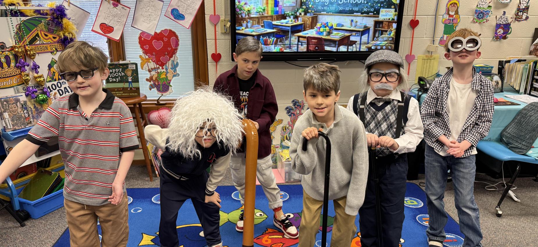Six kids dressed as elderly characters in a classroom setting.