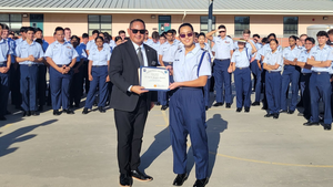 The Air Force Junior Reserve Officers' Training Corps member being presented with a certificate