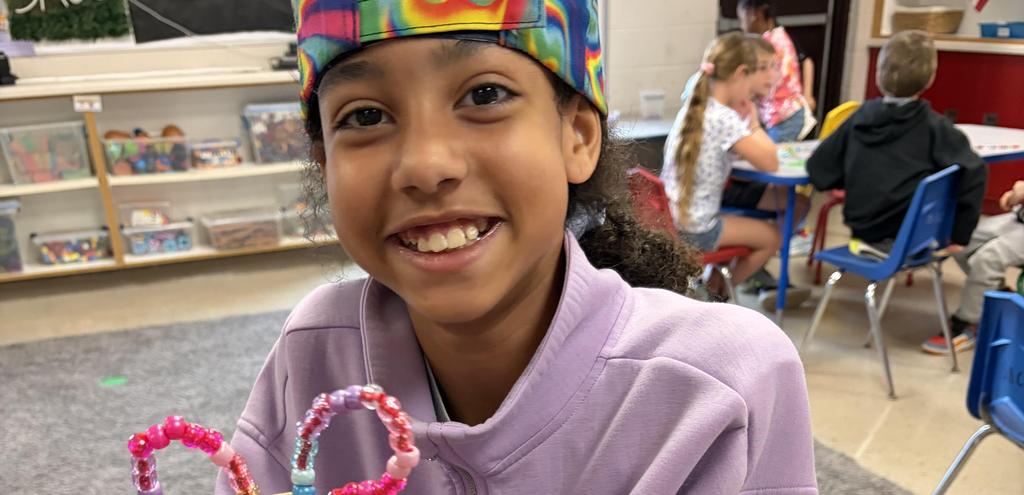 Making handmade butterfly craft made of beads.