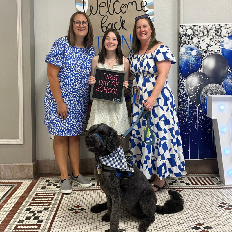 Teachers smile and pose for the first day of school. Corie, our therapy dog, joined the photo.