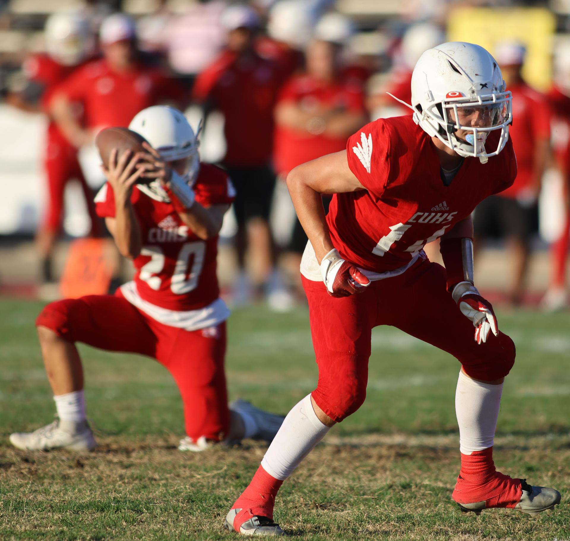 junior varsity football players in action against Fowler