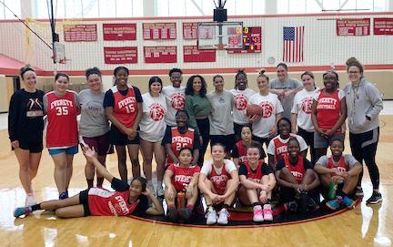 Informal group photo, basketball players on the court, after a game