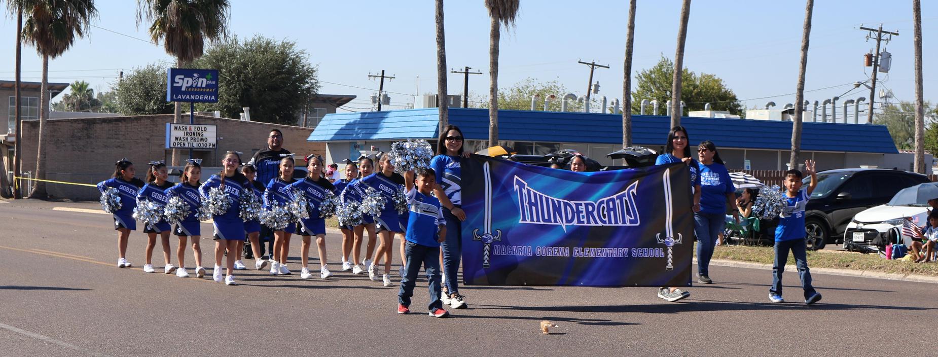 a picture of the Thundercat Cheer team in the City of Edinburg's Veterans Parade
