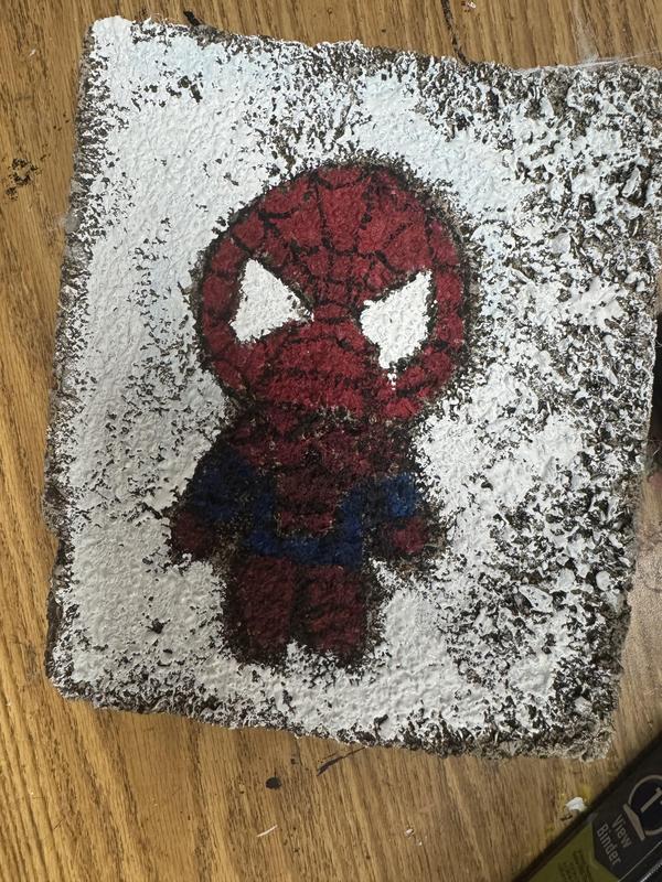 Spiderman painted on a rock