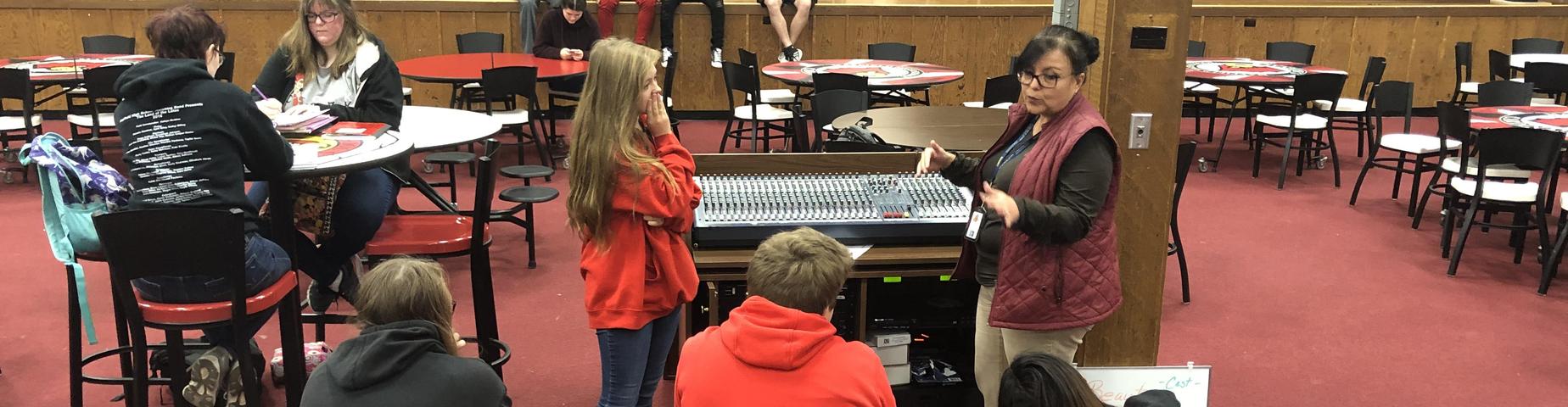 Mayfield High School teacher, Mrs. Martin is showing her Media Class how to work the sound board.