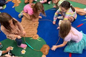 Lexi Kowalkowski, Adeline Jack, Addyson Hitchen, and Lucy Pavlovic work together to make the letter “O”