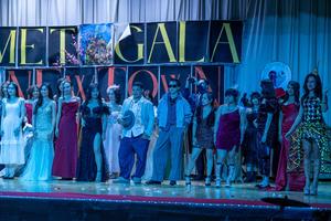 additional students with a cool/blue lighting on stage