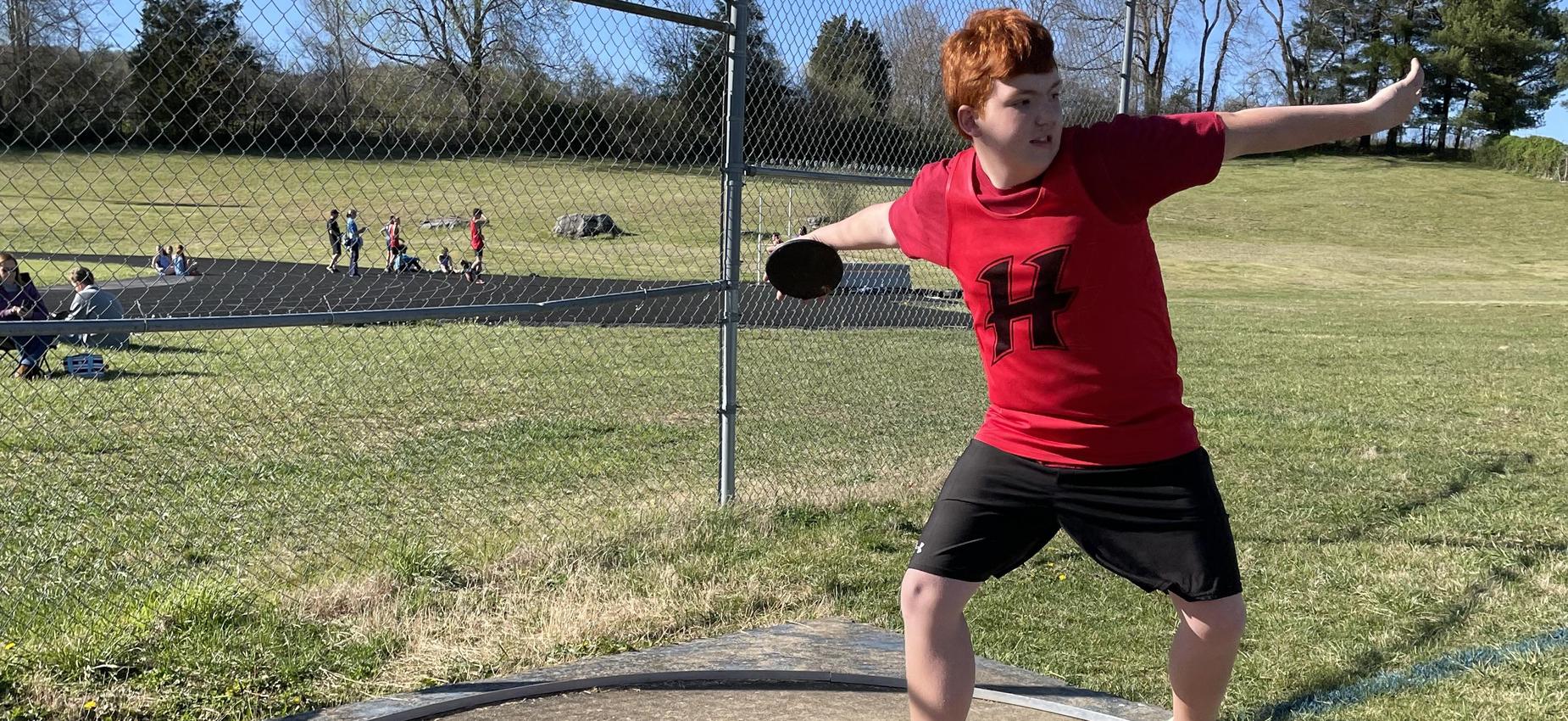 A student throws a discus.