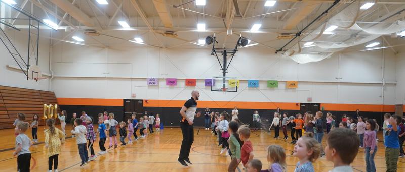 Students join in several physical activities with the PE teacher and the principal.