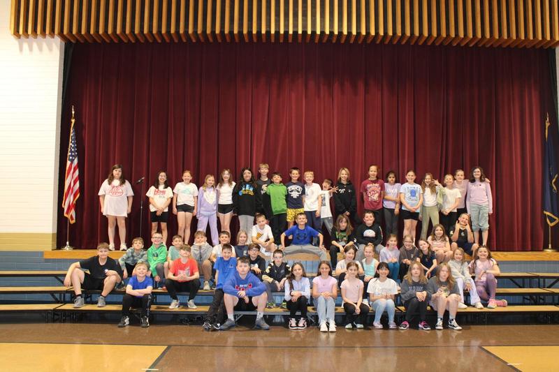 large group of students sitting on bleachers