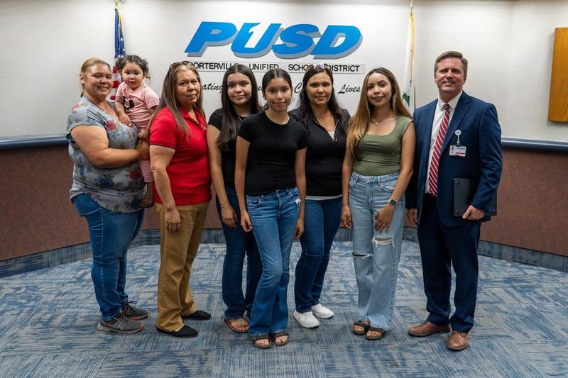 Strathmore High School senior Nayeli Prado stands with her family after being recognized for receiving The Gates Scholarship.