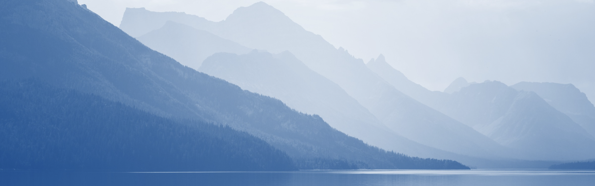 Landscape of rolling hills meeting a calm shoreline