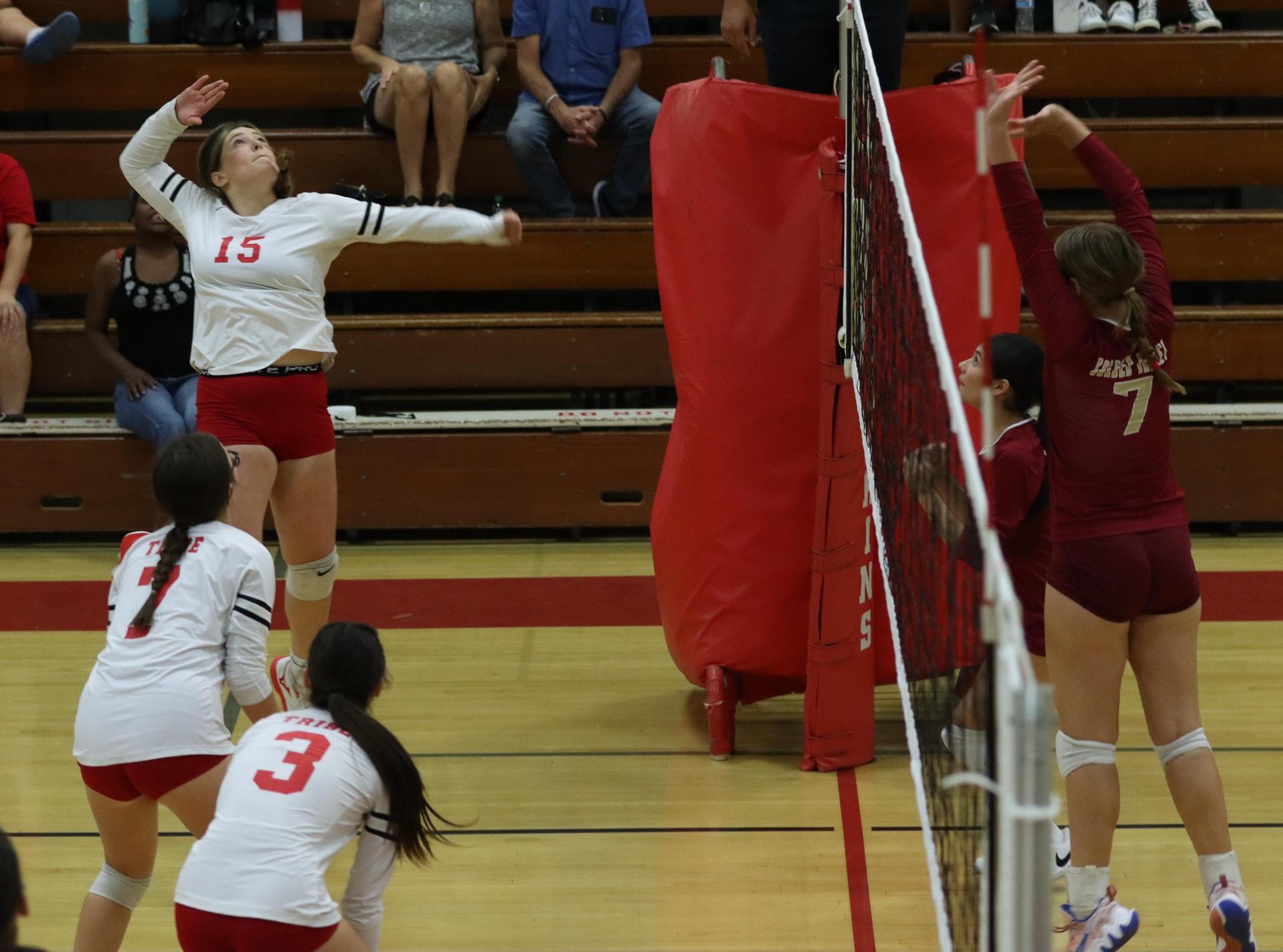 varsity volleyball players in action against golden valley