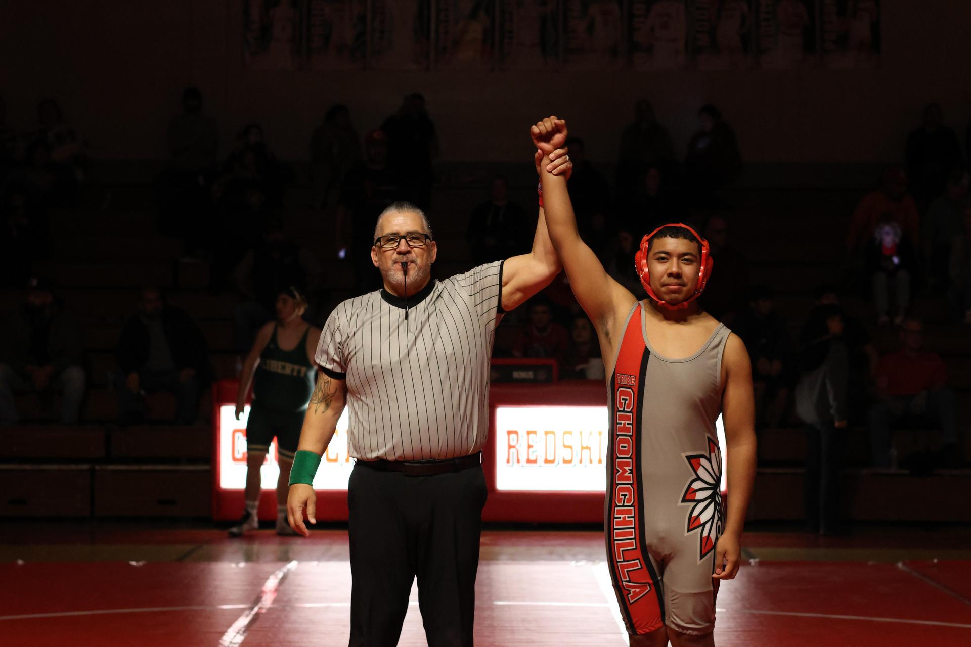 Wrestling winners with hands up 132