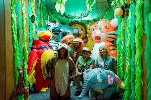 curriculum and instruction staff pose in jungle costumes