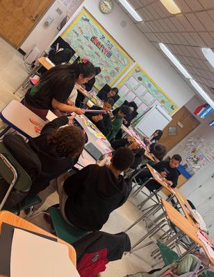 Students engaged in group work at classroom desks.