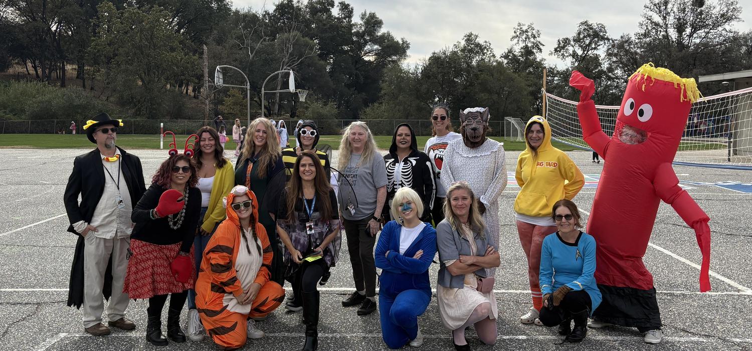 Arete Staff pose on the blacktop in costumes