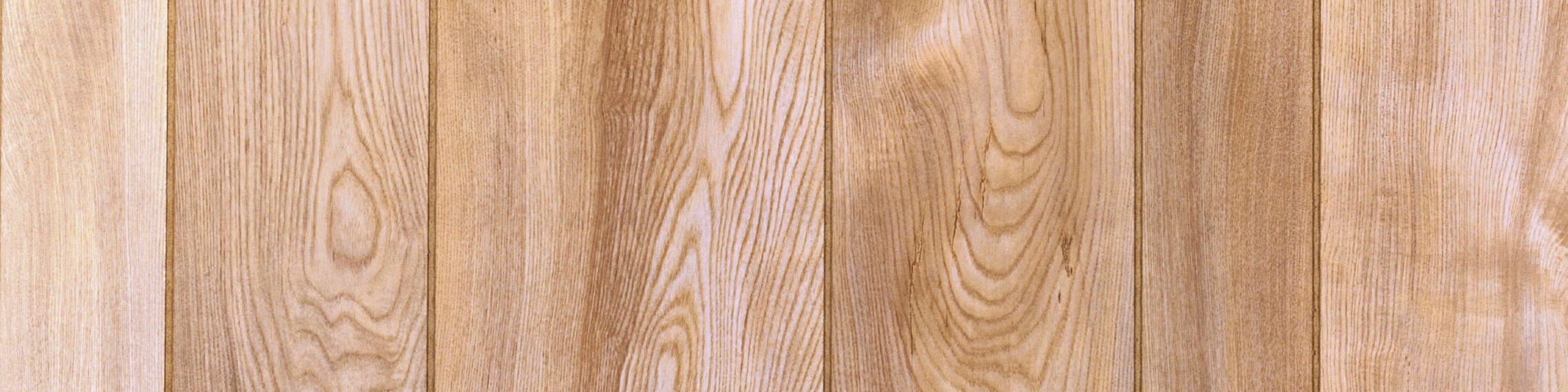 Close-up of light-colored wooden planks with visible grain patterns.