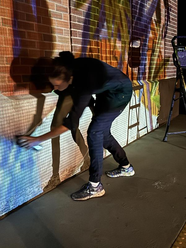 Mural Artist Painting On Building