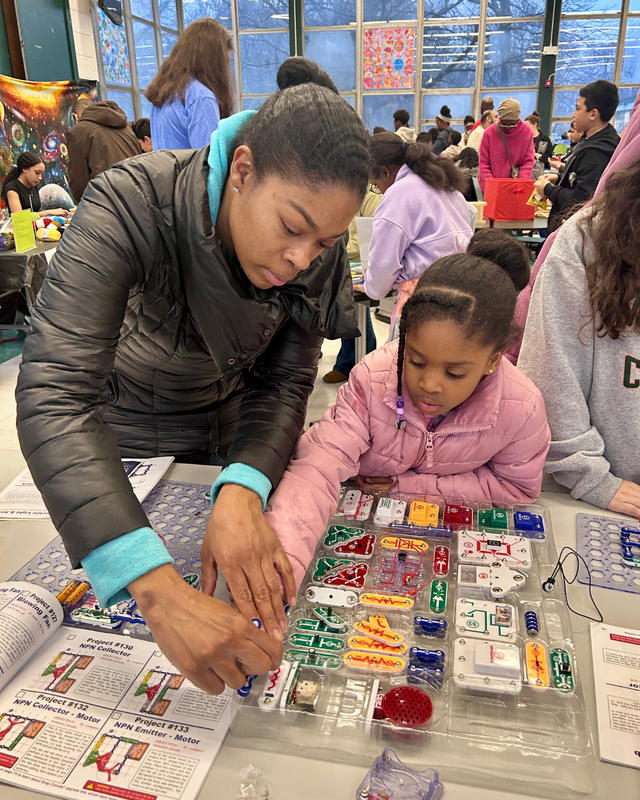 Adults work side by side with students to participate