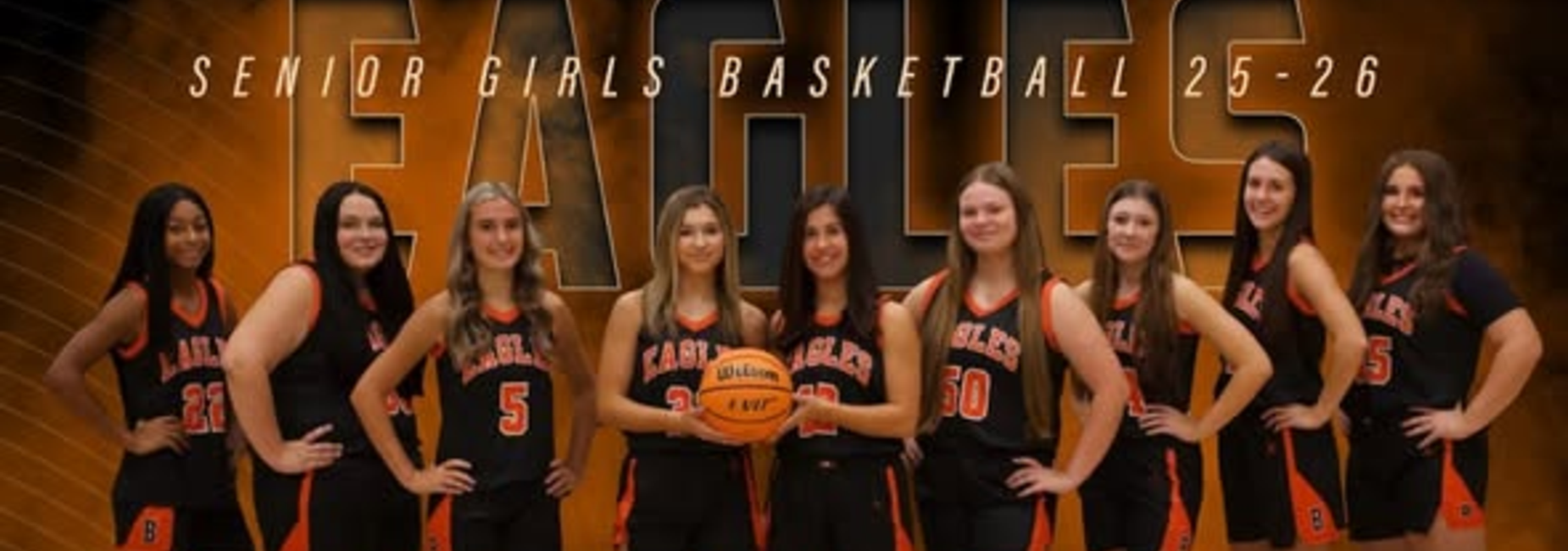 Team of senior girls basketball players posing with a basketball, labeled 'Eagles'.
