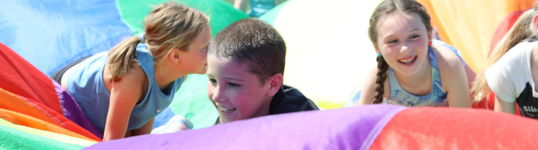 children at field day in parachute