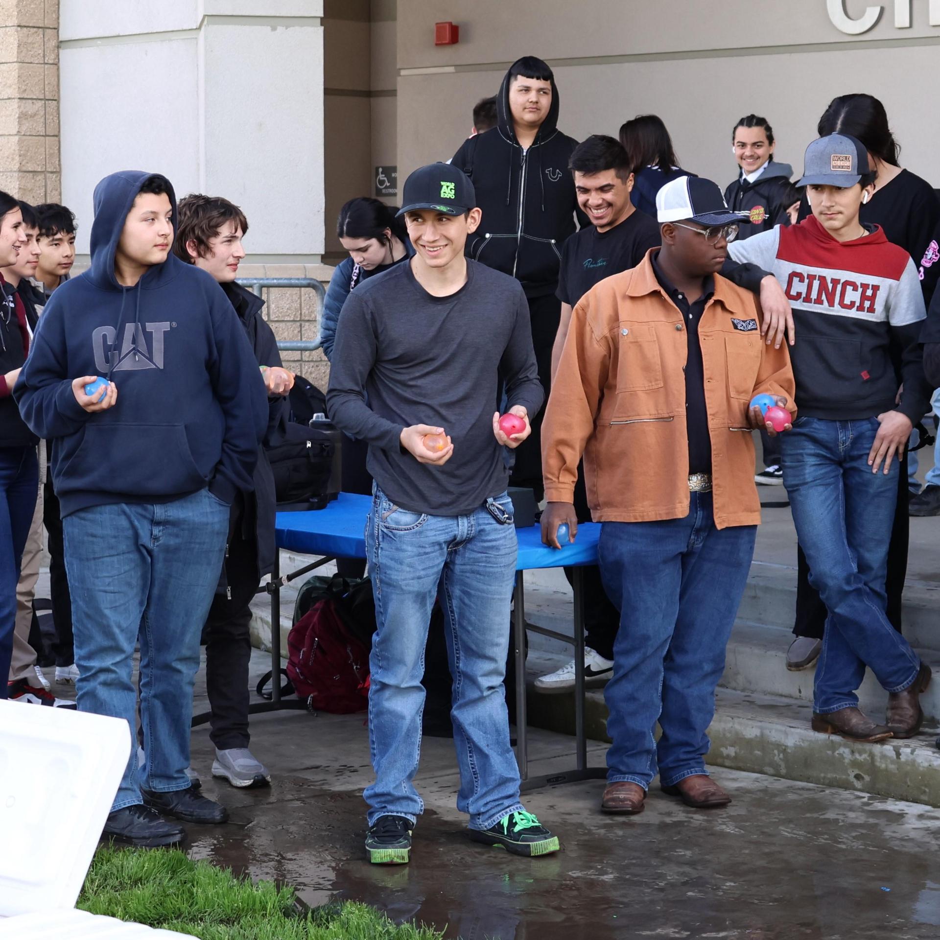 students and staff enjoying the water balloon toss
