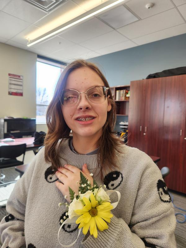 Leanna LeBathe holding her hand showing off the corsage she made.