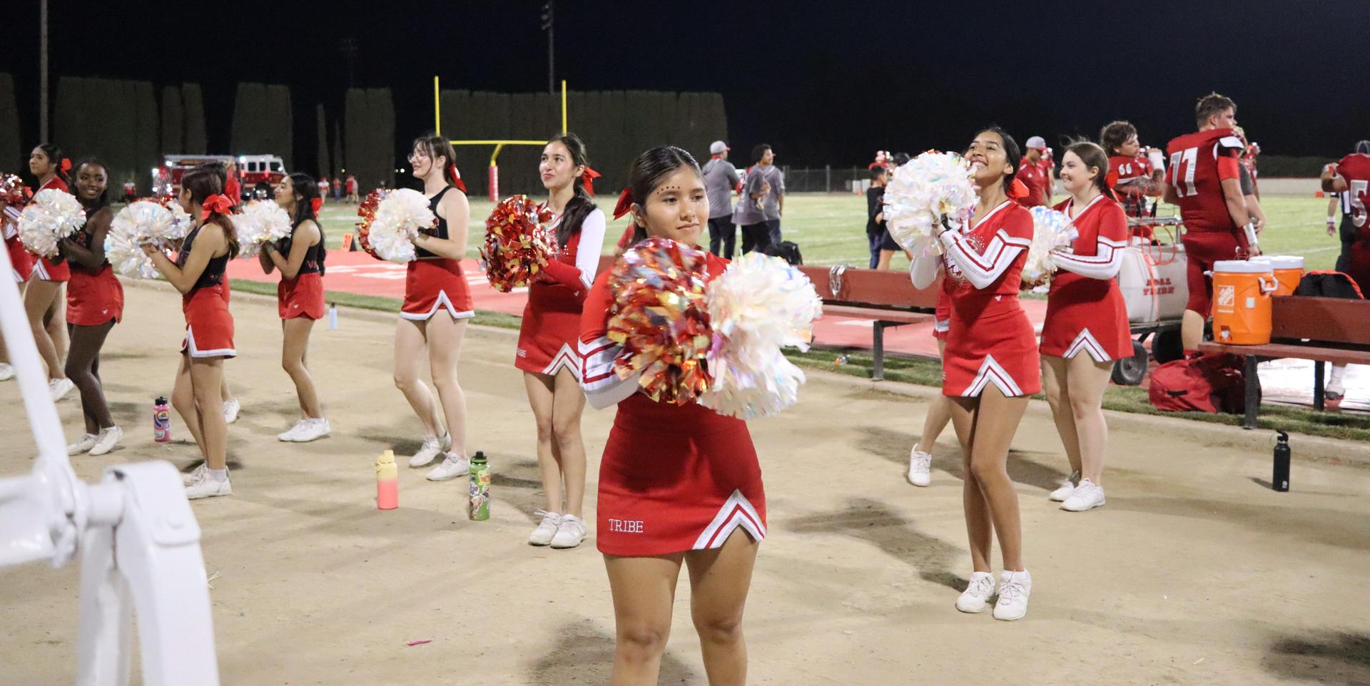 varsity cheerleaders in action at the Riverdale game