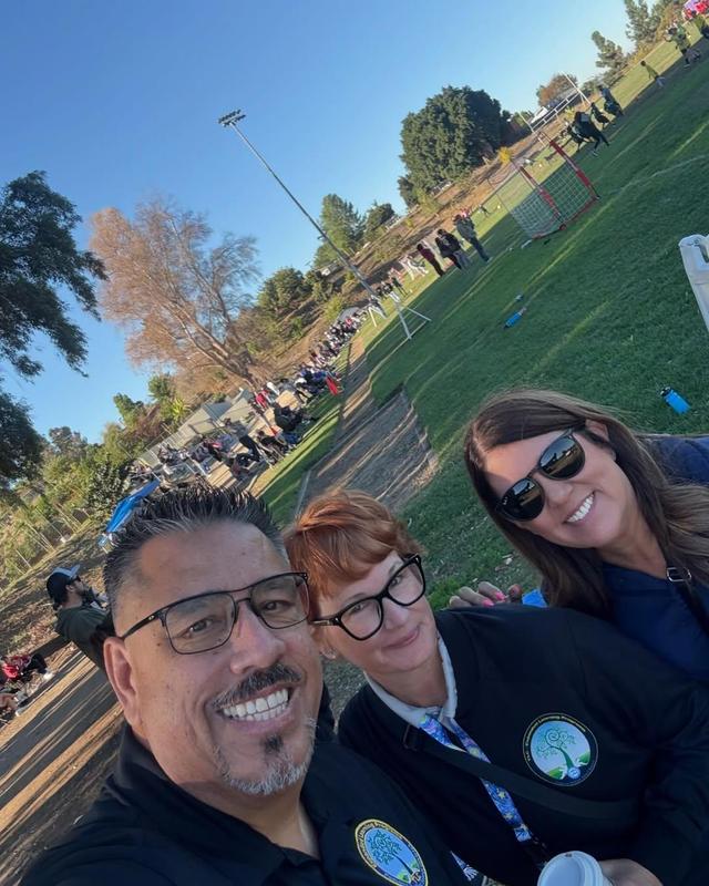 District staff at event pose for selfie