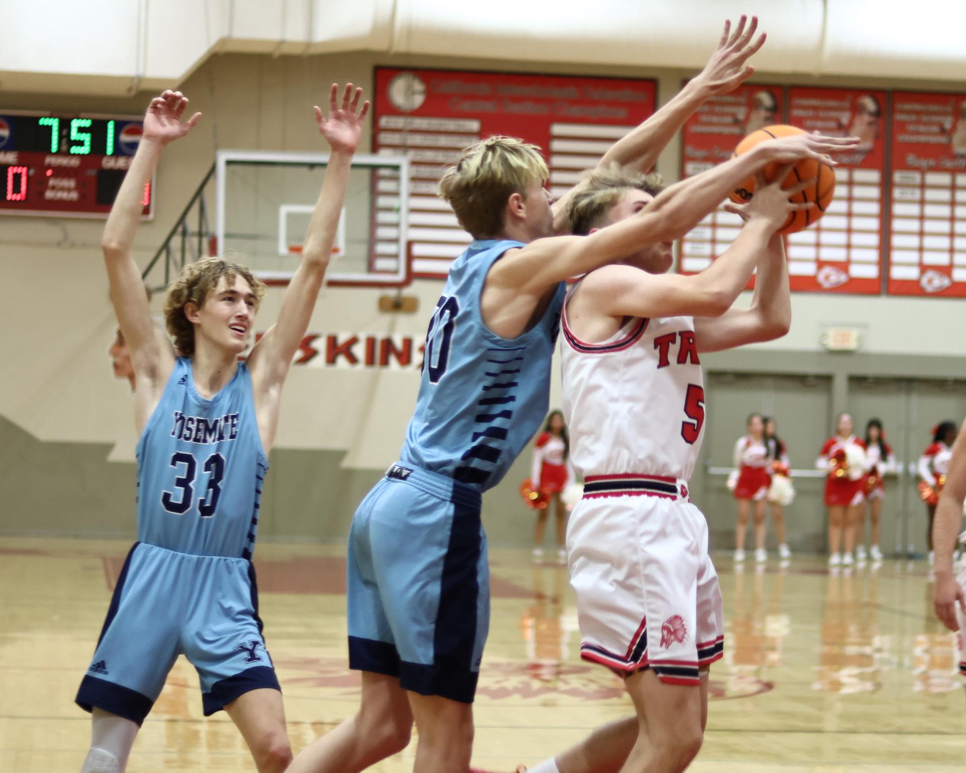 Varsity boys playing basketball against yosemite