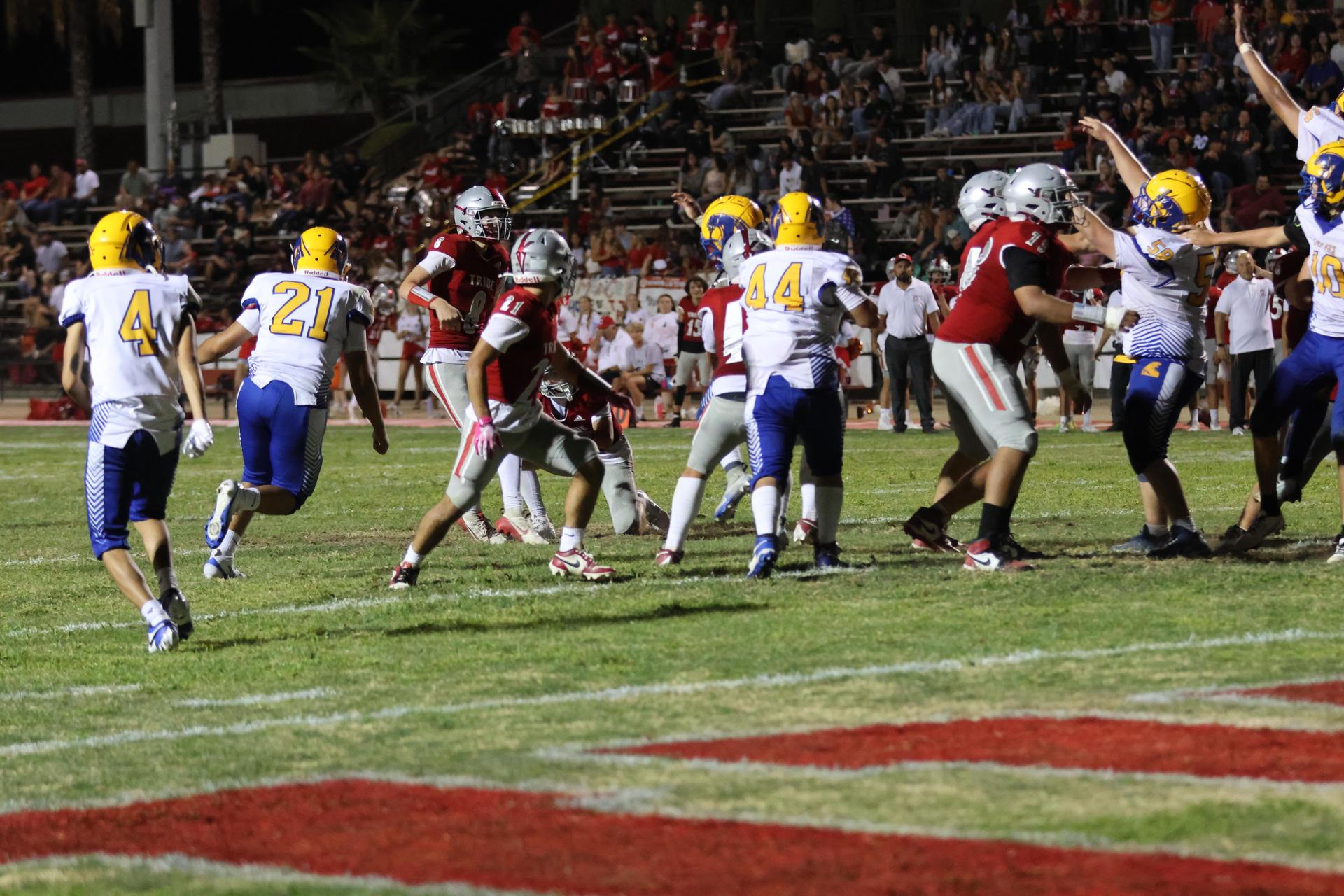 Varsity football players in action against Parlier 124