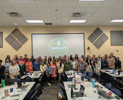 Group photo of participants in a classroom with an 'IMPACT' presentation displayed.