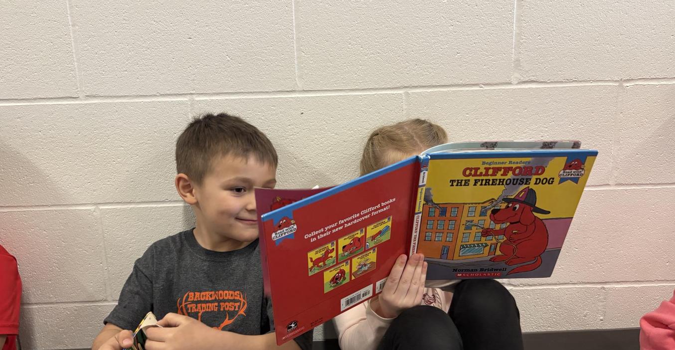 Two students share a book during Drop Everything and Read time.