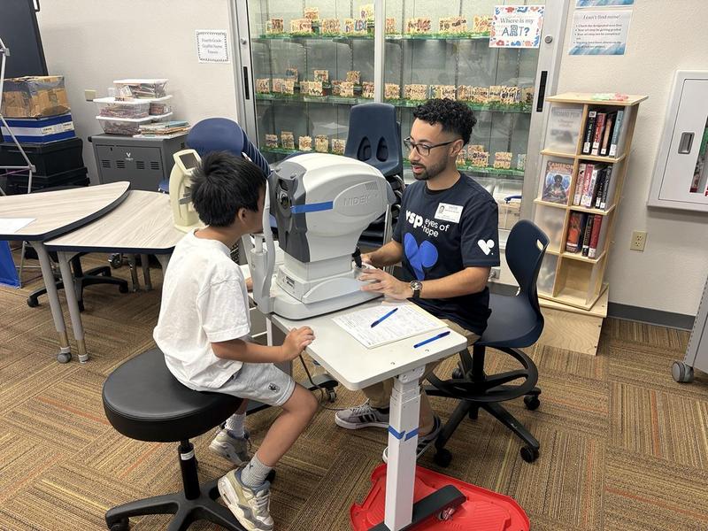 A student receives an eye exam